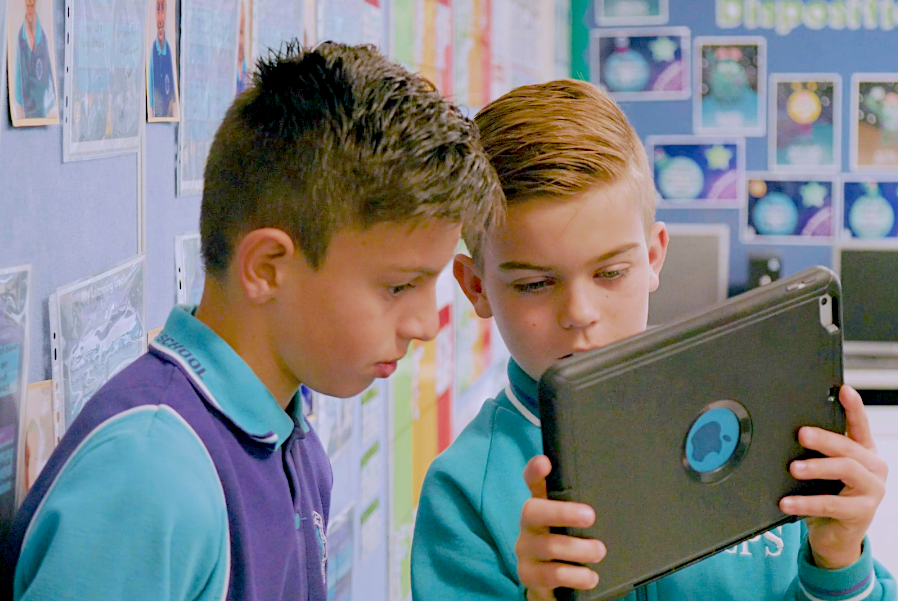 Two students looking at tablet year 56 copy_SCHOOLS-1